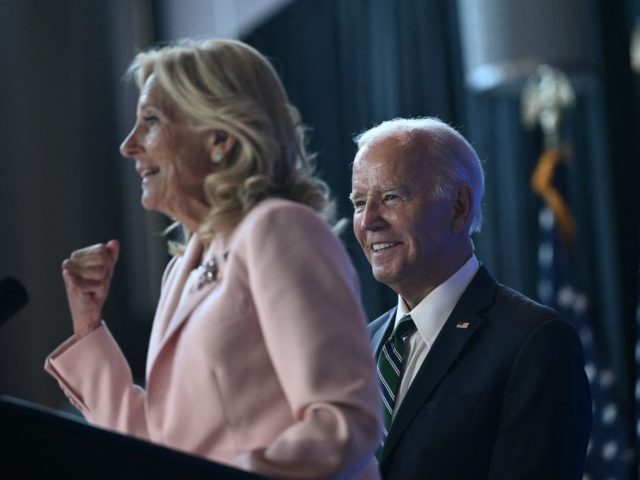 GettyImages-2166078707 US President Joe Biden looks on as First Lady Jill Biden speaks at a Biden Cancer Moonshot