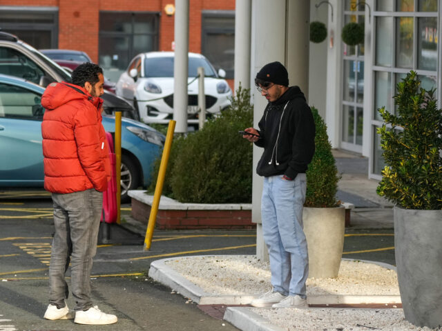 gettyimages-2184315746-1-640x480-1 ALTRINCHAM, ENGLAND - NOVEMBER 12: People stand outside the Cresta Court Hotel which is cu