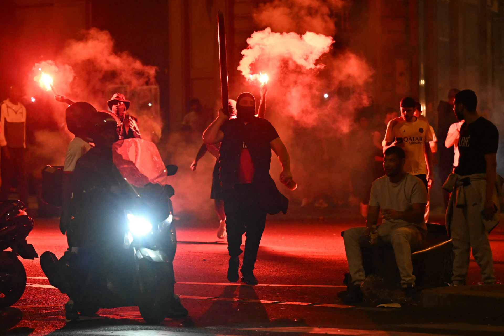 gettyimages-2217330576 Paris Saint-Germain (PSG) supporters gather holding flares on a street in Paris early June 1, 2025, during celebrations following their 5-0 victory in the UEFA Champions League final football match between Paris Saint-Germain (PSG) and Inter Milan held in Munich. (Photo by LOU BENOIST / AFP) (Photo by LOU BENOIST/AFP via Getty Images)