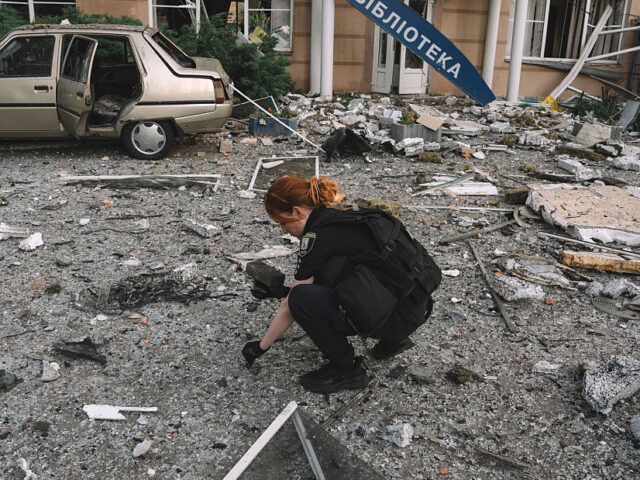 Russia Hits Kyiv with Missile Wave After Putin Vowed Reprisals A police officer collects drone missile parts at the site of a Russian overnight attack in