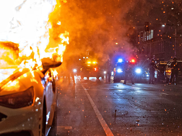 gettyimages-2218914246-640x480-1 A car burns on East 3rd street after protesters set a car on fire as demonstrators continu