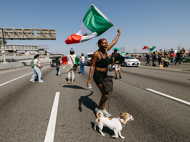 GettyImages-2219021826 A protester shouts while waving a Mexican flag as protests continue in Los Angeles on June