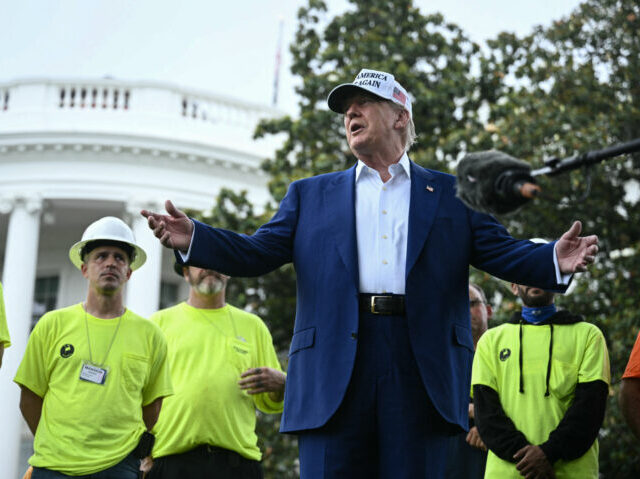 US-POLITICS-WHITE HOUSE US President Donald Trump speaks to the press as workers install a large flag pole on the