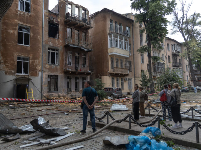 gettyimages-2220289184-1-640x480-1 Local residents look at damaged residential buildings following the Russian drone attack i