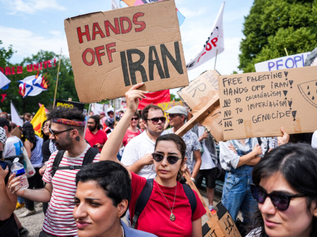 gettyimages-2220713685-1-640x480-1 A protestor holds signs during a demonstration against the government of Israel ahead of t