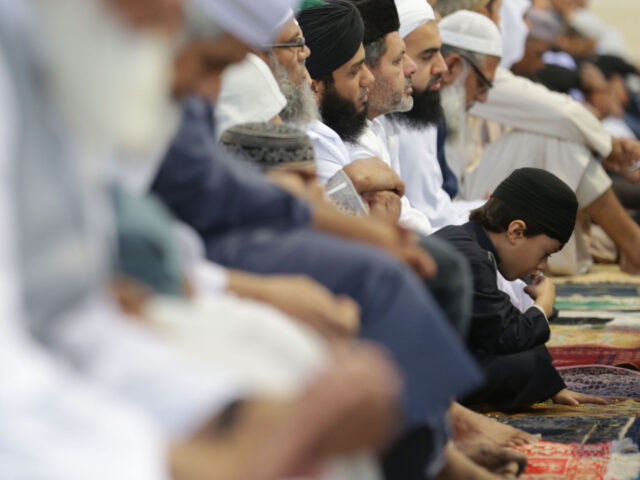 gettyimages-545169874-1-640x480-1 A child leans forward as people gather for a large communal prayer at the velodrome of Sai