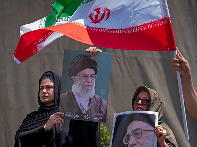 gettyimages2219238911-640x480-1 Iranian worshippers hold portraits of Iran's Supreme Leader, Ayatollah Ali Khamenei, and a