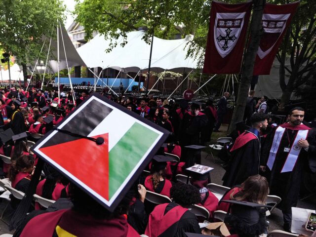 Harvard Palestinian (Charles Krupa / Associated Press) A student displays the Palestinian flag on his mortar board as graduates take their seats