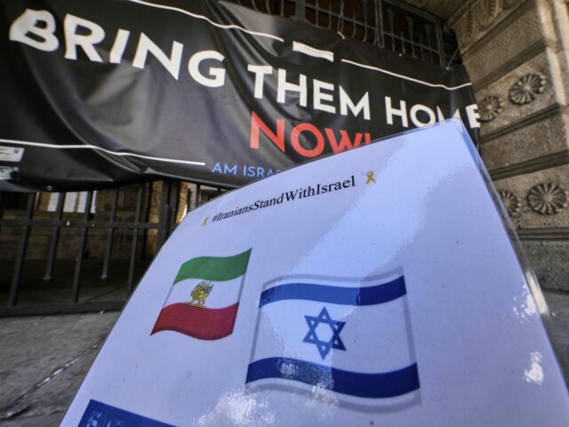 Israel Iran friendship (Michael Probst / Associated Press) A sign with an Iranian and Israeli flag that was set up up a while ago is pictured at the