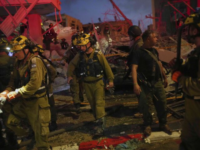 Israel missile strike (Ohad Zwigenberg / Associated Press) Israeli security forces inspect destroyed buildings that were hit by a missile fired from