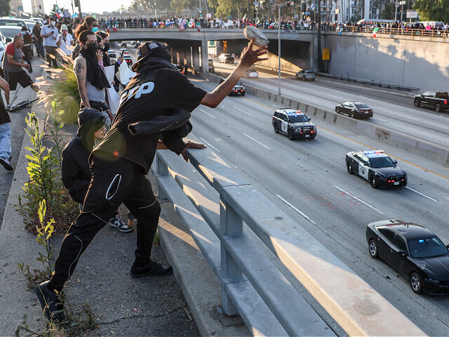 Los Angeles, CA, Sunday, June 8, 2025 - Protesters throw rocks from Aliso St. at CHP offic