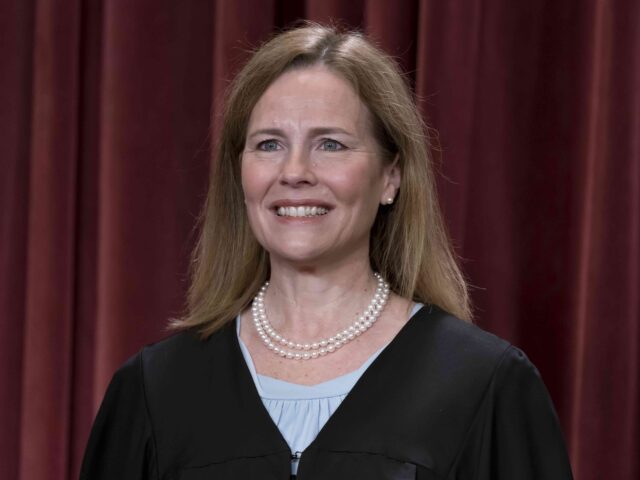 Associate Justice Amy Coney Barrett joins other members of the Supreme Court as they pose