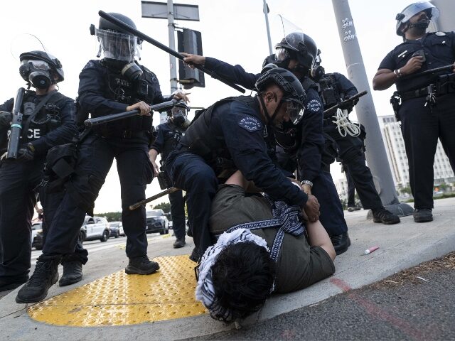 la-ice-raid-riot-arrest-getty LOS ANGELES, CALIFORNIA - JUNE 06: LAPD officers arrest a protester outside of the Federal