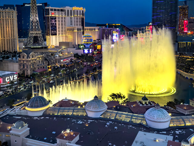 Las Vegas Strip The Bellagio Water Fountain Show is viewed at dusk from Caesars Palace Hotel & Casino