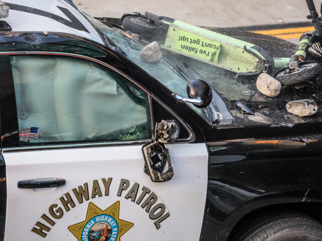 Los Angeles Riots damaged police car Los Angeles, CA, Sunday, June 8, 2025 - Rocks and a scooter thrown from an overpass lay on