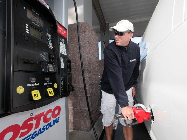 man-pumping-gas-Costco-ap Michael Dytrych fuels up at the Costco gas station in Sacramento, Calif., Friday, Oct. 5,