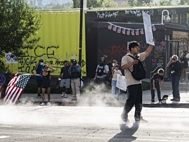 CALIFORNIA, UNITED STATES - JUNE 14: A protester seen standing his ground as pepper ball r