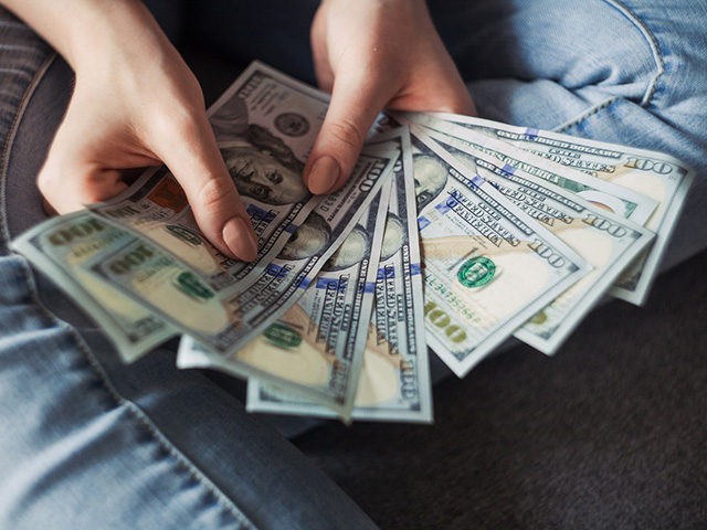hundred dollar bills person-holding-100-us-dollar-banknotes-2068975