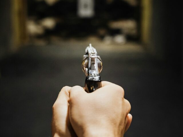 pexels-karolina-grabowska-5202392 Hands of a Person Aiming a Handgun