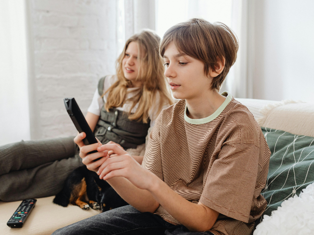 pexels-karolina-grabowska-7693598 A Boy Holding a TV Remote