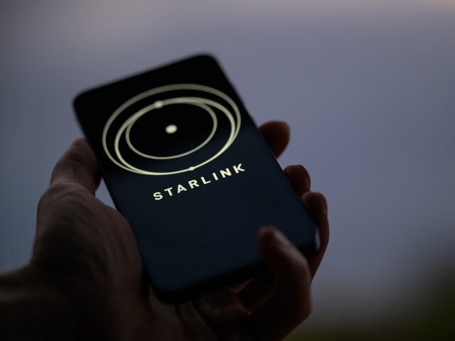 The Starlink logo is displayed on a mobile phone in this photo illustration in Brussels, B