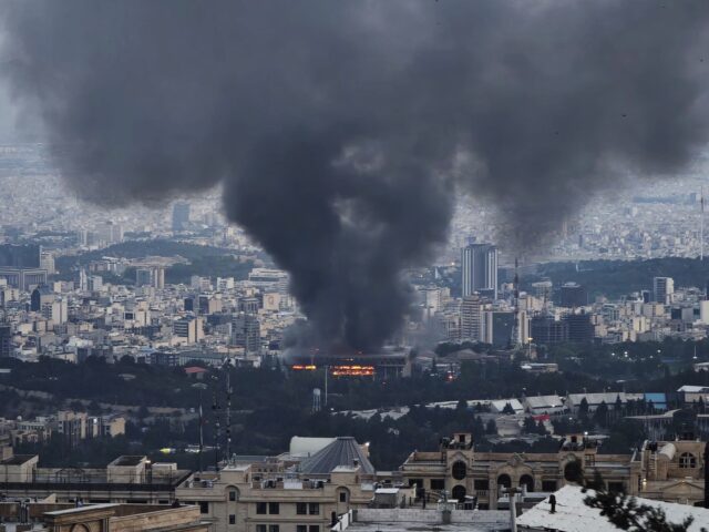 Tehran burning (Getty) TEHRAN, IRAN - JUNE 16: Smoke rises after a reported Israeli strike on a building used by
