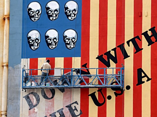 tehran mural down with usa A man on a platform applies a fresh coat of paint to the landmark anti-US mural drawn on t