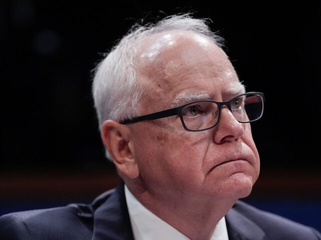 Minnesota Gov. Tim Walz listens to Representatives speak during a House Committee on Overs