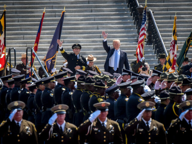 Trump and President Fraternal Order of Police and Officers President Trump, right, waves to the crowd as he arrives with Chuck Canterbury, left, Pres