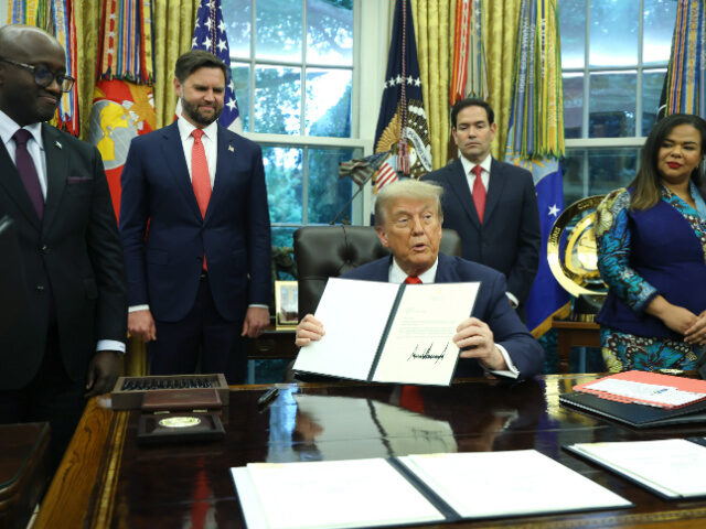 Trump, Congo, Rawanda U.S. President Donald Trump sigs a letter of congratulations as he meets with Minister of