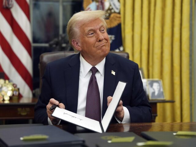Trump smirk shrug (Evan Vucci / Associated Press, File) FILE - President Donald Trump signs executive orders in the Oval Office of the White House