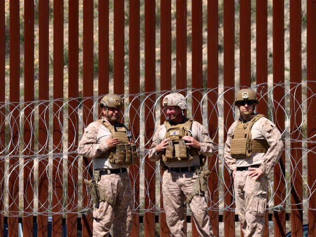 U.S. Military at southern border Members of the U.S. military stand in front of the border wall along the U.S. and Mexico b