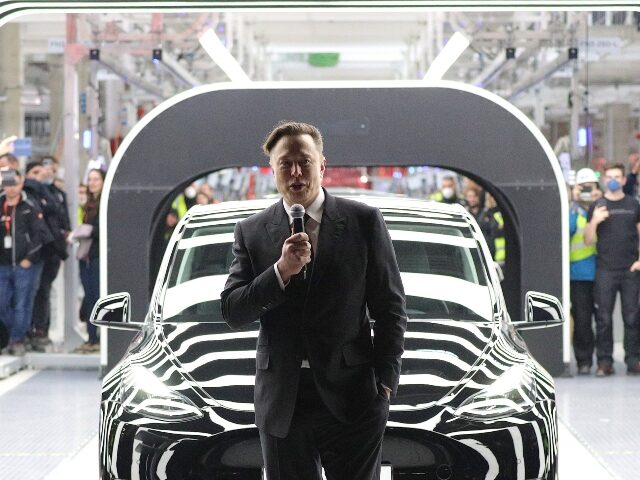 Elon Musk speaking at a Tesla factory