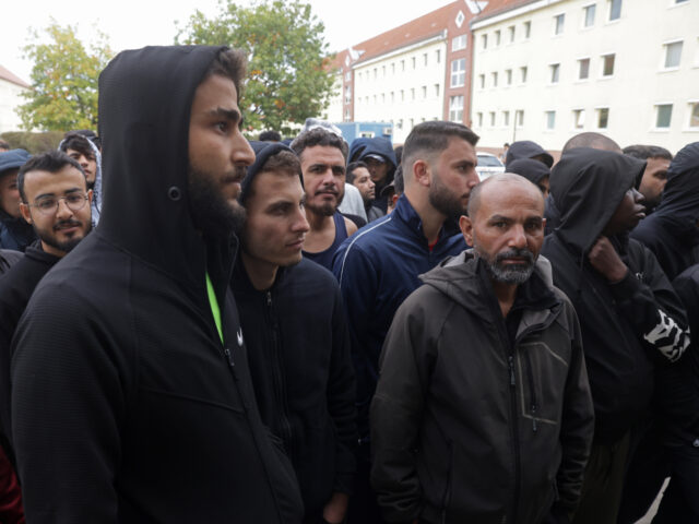 gettyimages-1718514938-1-640x480-1 EISENHUETTENSTADT, GERMANY - OCTOBER 05: Men, most of them from Syria, queue for lunch at