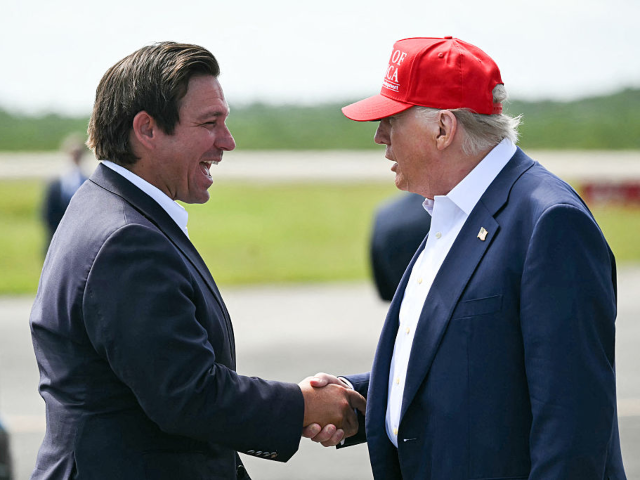 GettyImages-2222312639 Florida Governor Ron DeSantis shakes hands with US President Donald Trump upon Trump's arr
