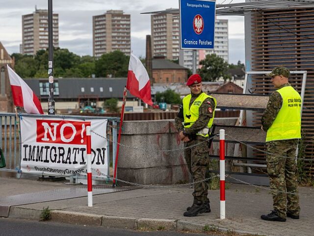 POLAND-GERMANY-LITHUANIA-DIPLOMACY-MIGRATION Banners reading "Stop Immigration" and "No! Immigration" are seen as P
