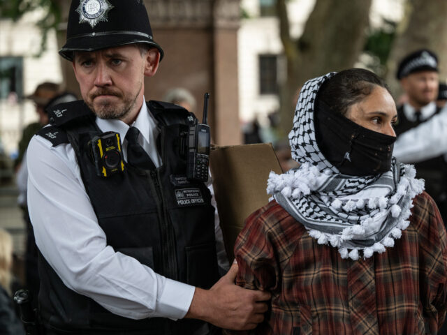 LONDON, ENGLAND - JULY 5: An activist is arrested on July 5, 2025 in London, England. Following yesterday's failed legal challenge, the Home Secretary's order to proscribe Palestine Action as a terrorist group has become law. Today a group of supporters, including a priest, an Emeritus Professor and an emergency care worker, just back from Gaza, sat down in front of the Gandhi statue in Parliament Square holding signs saying, "I oppose genocide. I support Palestine Action." (Photo by Guy Smallman/Getty Images) LONDON, ENGLAND - JULY 5: An activist is arrested on July 5, 2025 in London, England. Foll