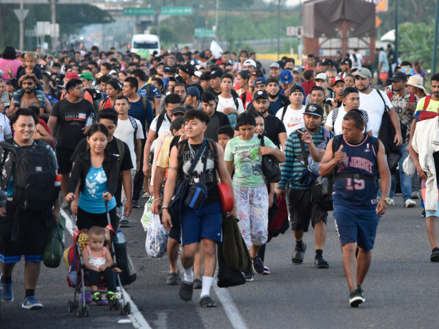 Mass Migration (2) Migrants walk along the highway through Suchiate, Chiapas state in southern Mexico, Sunday