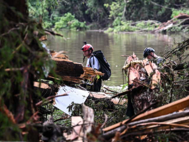 Rescue Workers Search Near Camp Mystic Members of a search and rescue team look for people near Camp Mystic, the site of where at