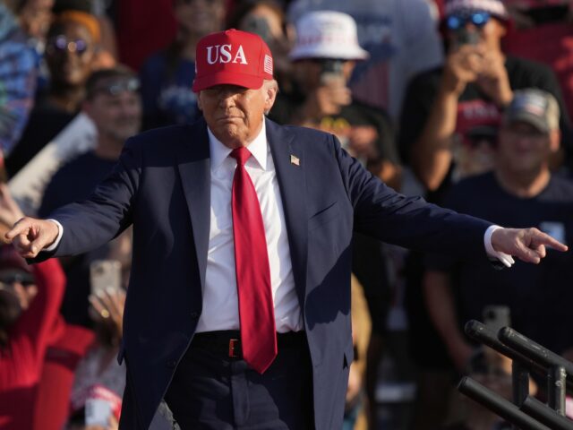 Trump fingers (Charlie Neibergall / Associated Press) President Donald Trump arrives to speak at a rally at the Iowa State Fairgrounds, Thursday